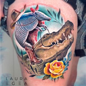 color realism tattoo of cowboy armadillo riding an alligator by Laura Egea Dallas Texas