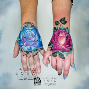 Color realism couple flower tattoo on a hand created by award-winning international tattoo artist Laura Egea based in Dallas Texas